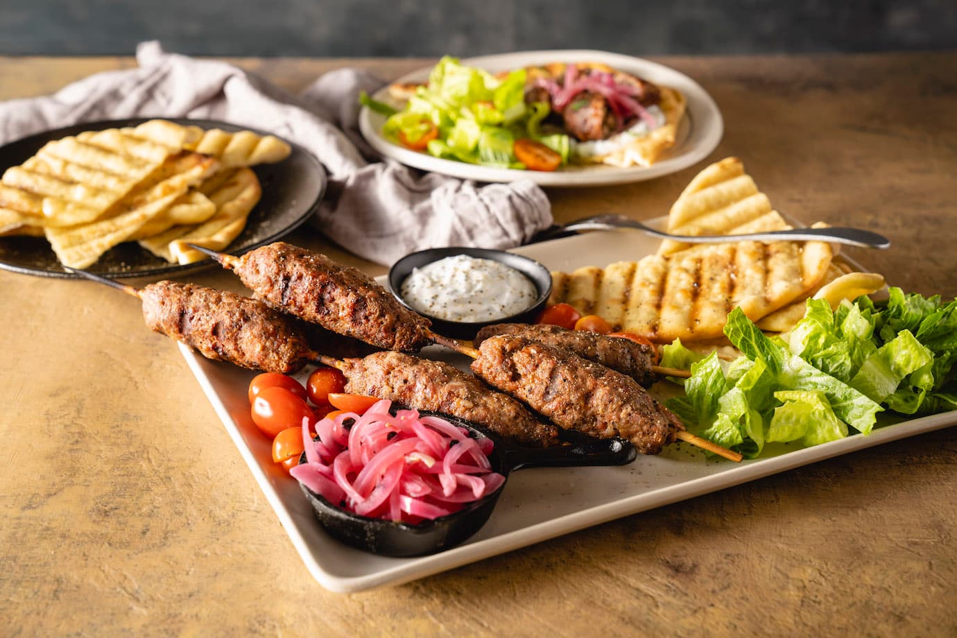 Pork Skewers with Grilled Pita and Pickled Red Onions